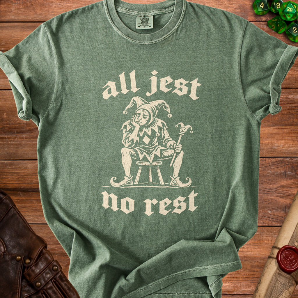 Green t-shirt with a sad jester graphic and text "all jest no rest".