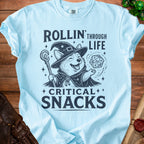 Corgi wizard with dice and staff on light blue t-shirt, text reads "Rollin' Through Life Critical Snacks".