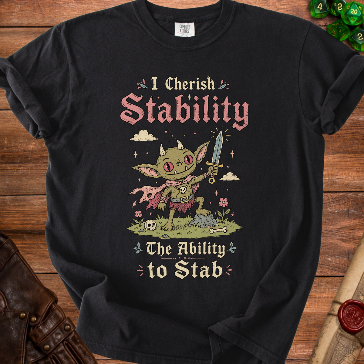 Black t-shirt with a goblin character holding a sword and the text "I Cherish Stability The Ability to Stab".