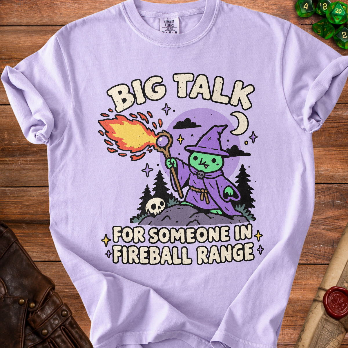 Purple t-shirt with cartoon wizard casting fireball and text "BIG TALK FOR SOMEONE IN FIREBALL RANGE".