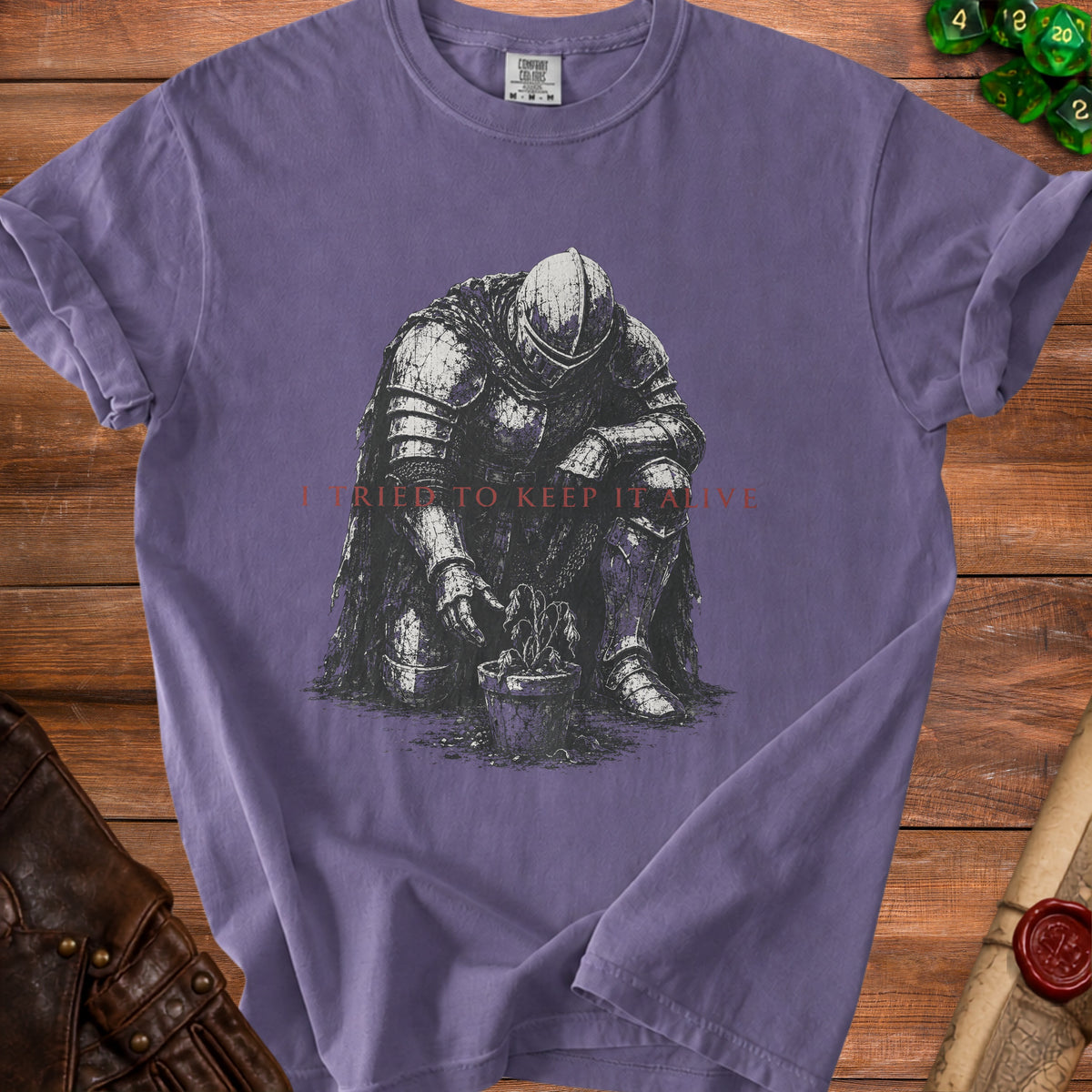Purple t-shirt with a knight tending a wilting plant and text "I TRIED TO KEEP IT ALIVE".