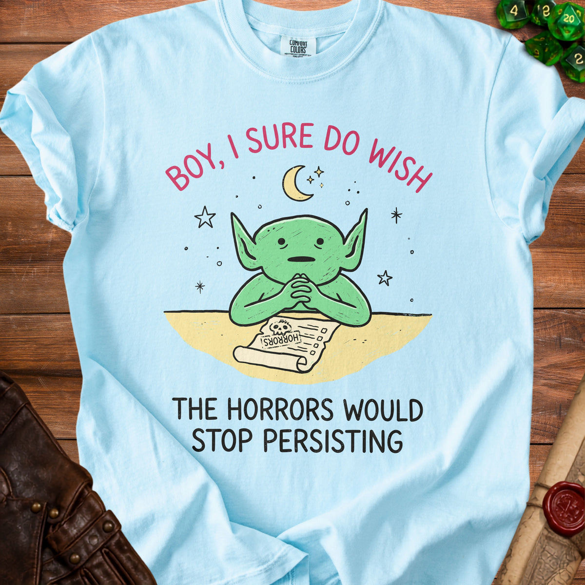 Light blue t-shirt with green goblin wishing "Boy, I sure do wish the horrors would stop persisting."