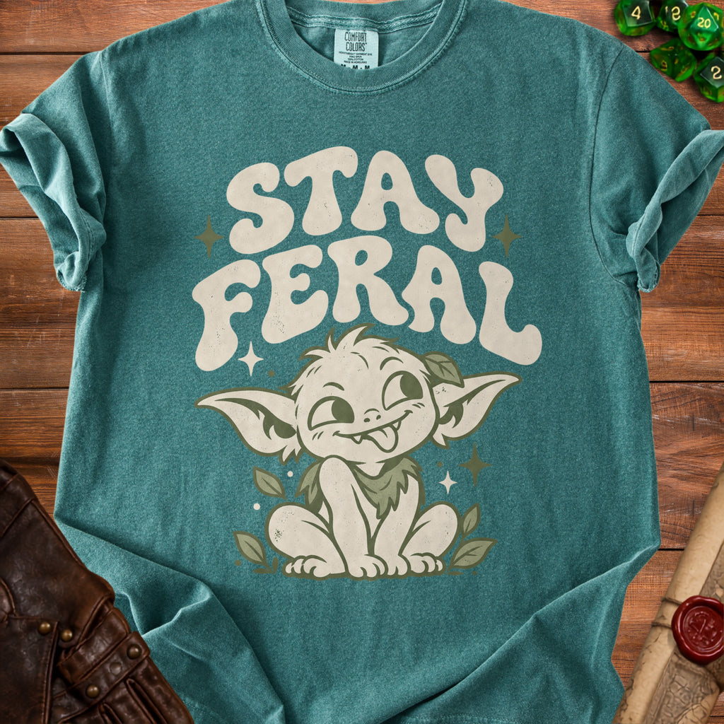 Teal t-shirt with "STAY FERAL" text and a whimsical creature illustration.