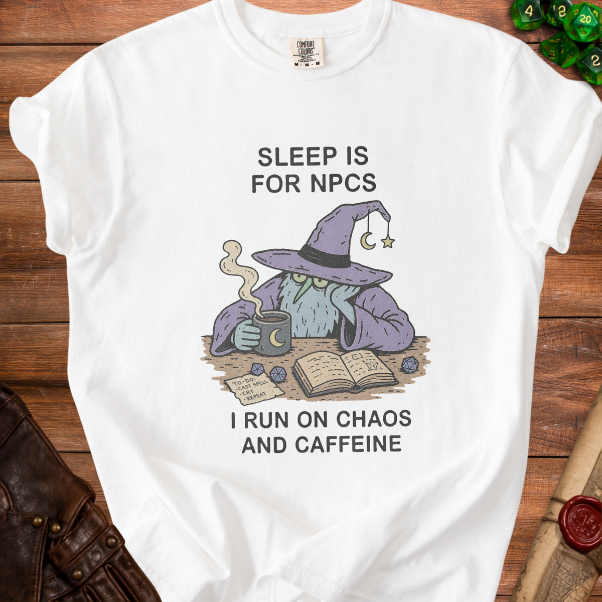 White t-shirt with wizard graphic, text "Sleep is for NPCs" and "I run on chaos and caffeine".