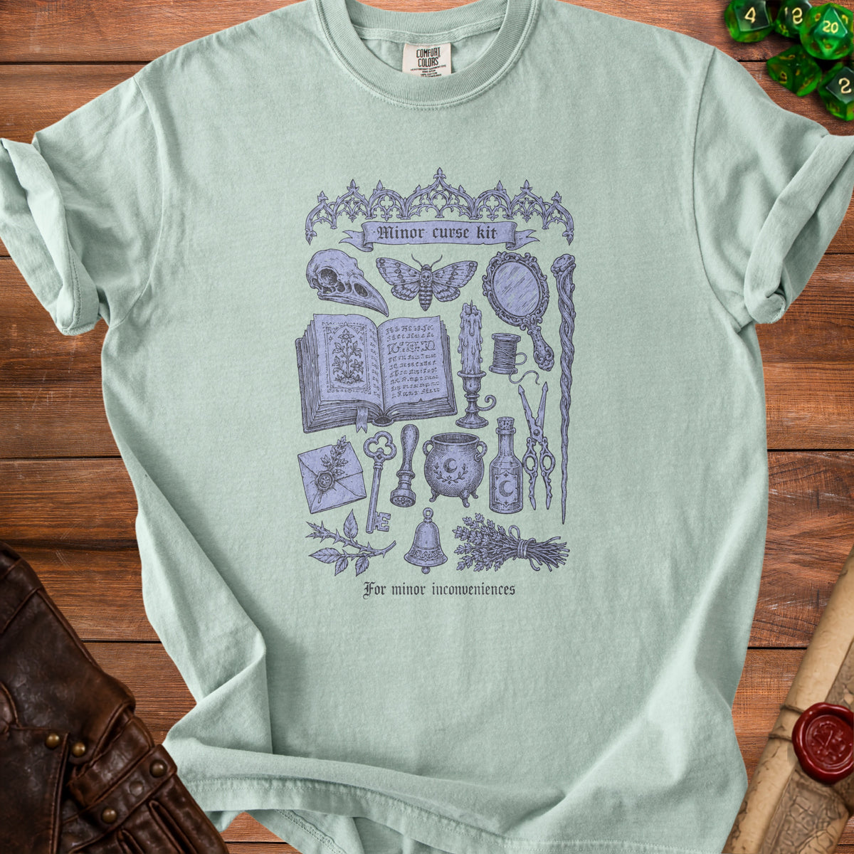 Light blue t-shirt with "Minor curse kit" and occult illustrations.