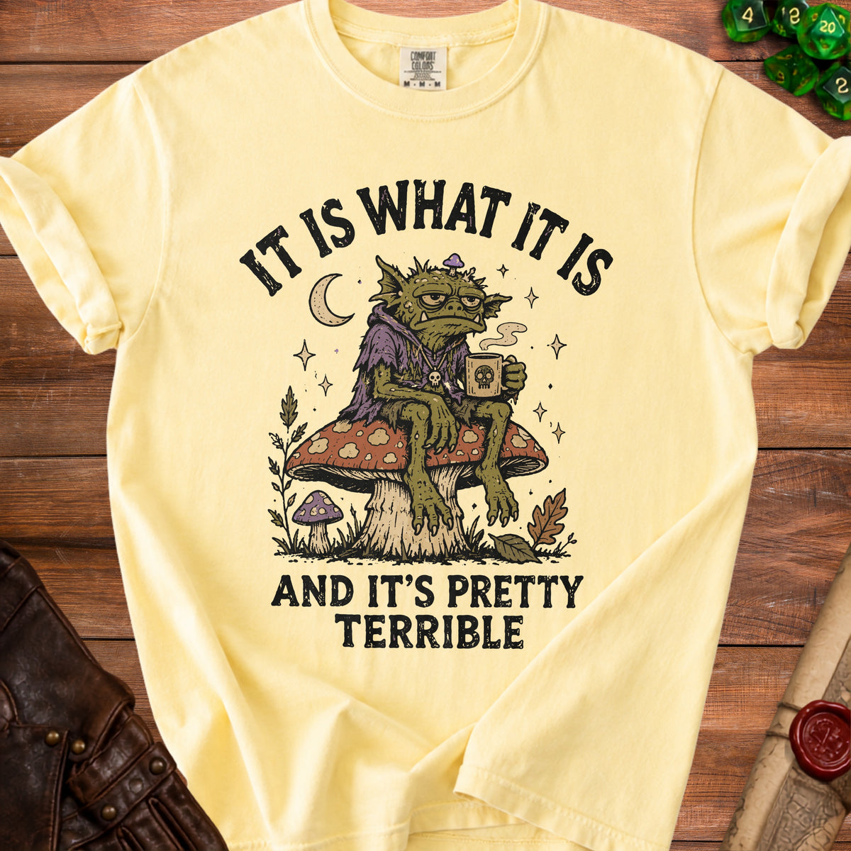 Yellow t-shirt with a goblin graphic saying "It is what it is and it's pretty terrible."