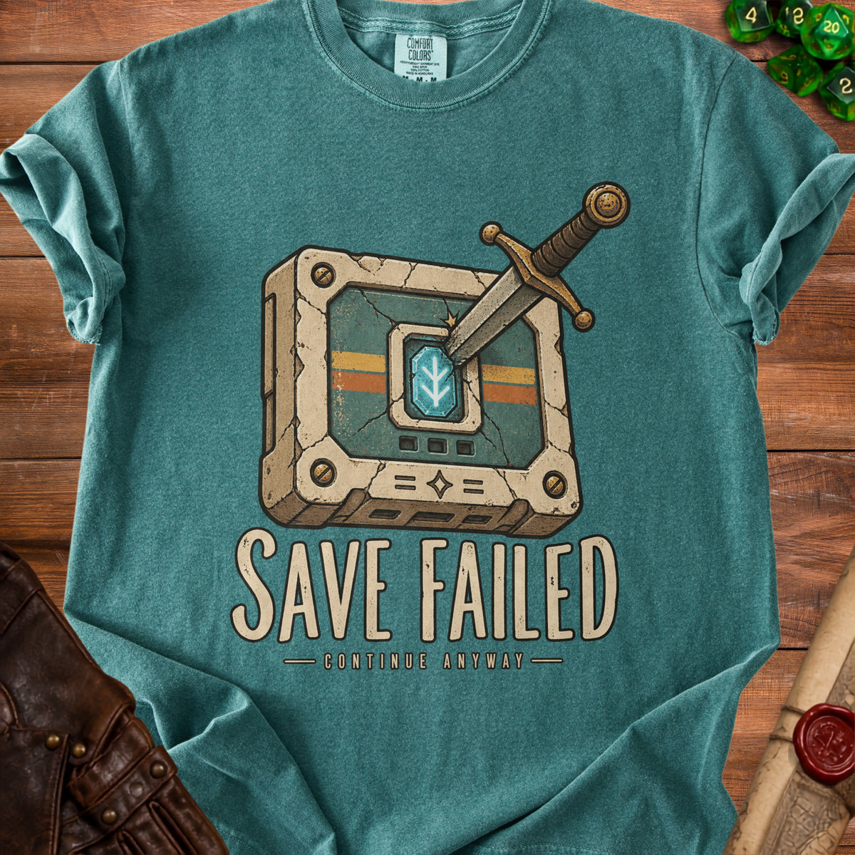 Teal t-shirt with a graphic of a sword in a cracked, ancient-looking block and text "SAVE FAILED CONTINUE ANYWAY".