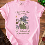 Pink t-shirt with a mushroom adventurer graphic and text about adventure.