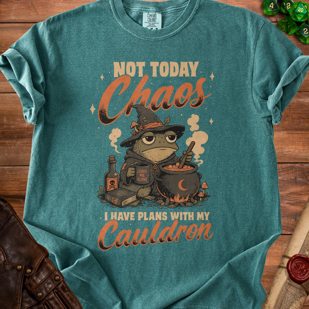 Green t-shirt with a toad in a witch hat, cauldron, and text "Not Today Chaos I Have Plans With My Cauldron".