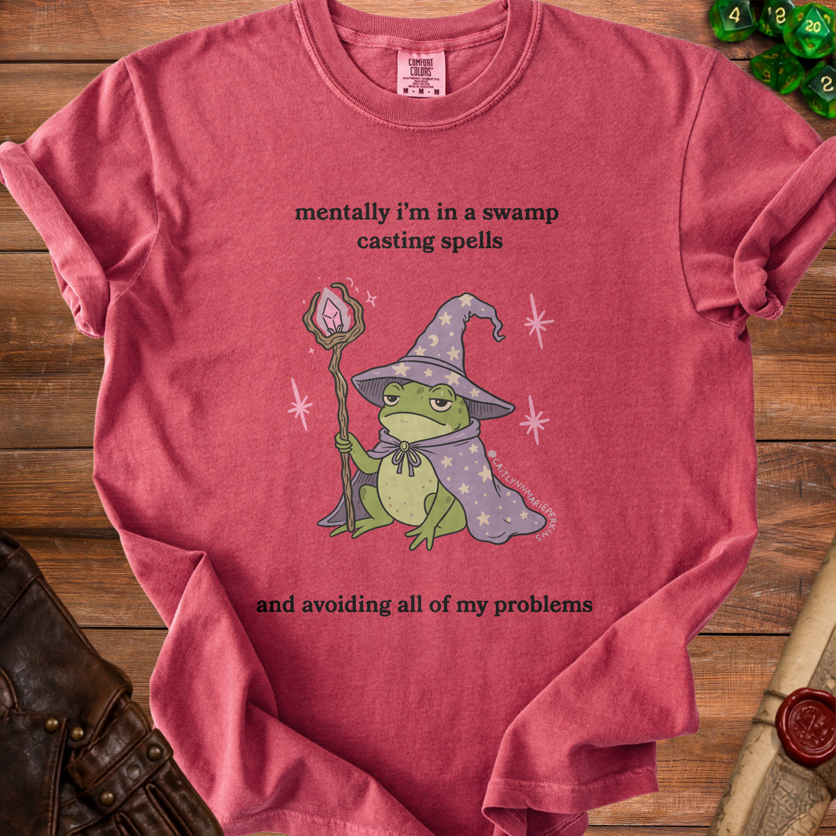 Red t-shirt with frog wizard and text: "mentally i'm in a swamp casting spells and avoiding all of my problems"