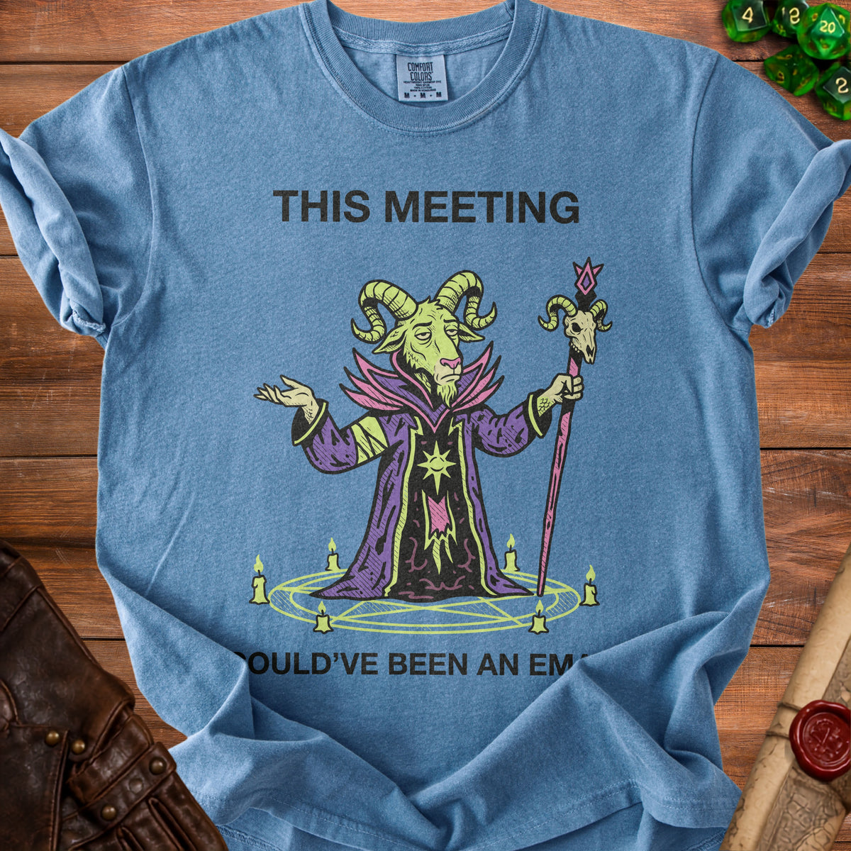Blue t-shirt with text "THIS MEETING" and a goat wizard graphic.