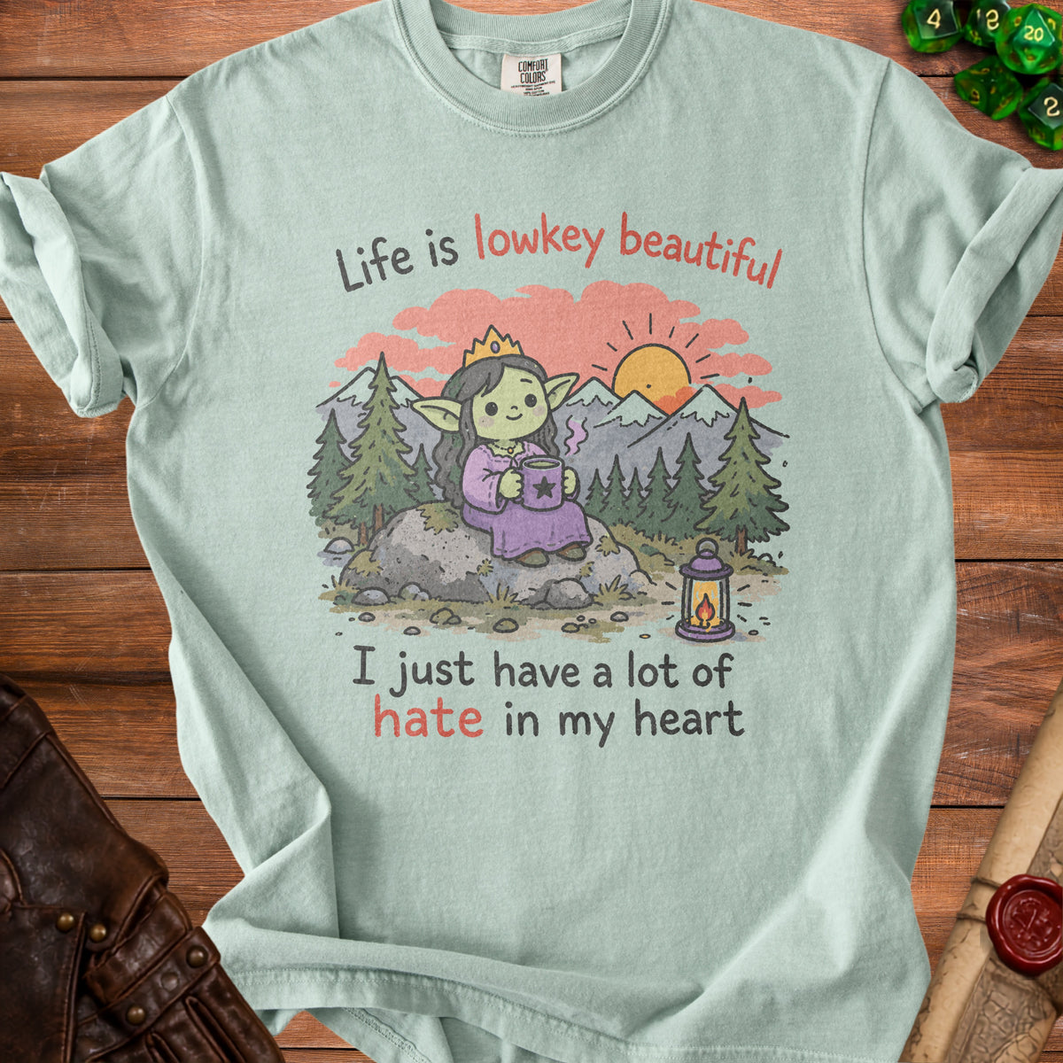 T-shirt with a cartoon goblin wearing a crown, holding a mug, with text "Life is lowkey beautiful".