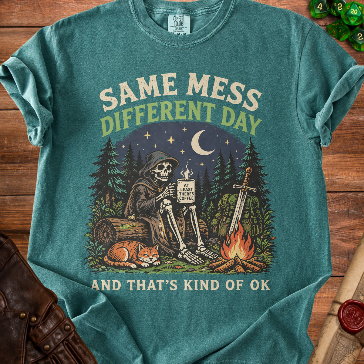 T-shirt graphic of skeleton with cat, coffee, and campfire under moon.