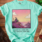 Mint green t-shirt with knight overlooking castle and river, reads "IDGAF IN A GOOD WAY.. IT'S PEACEFUL OVER HERE".