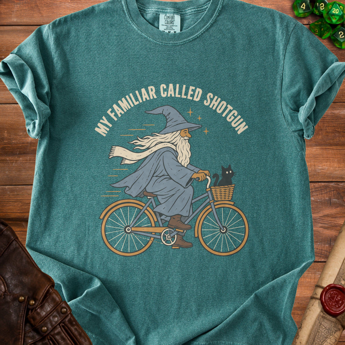 Wizard riding bicycle with cat in basket, text "MY FAMILIAR CALLED SHOTGUN".