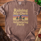 Brown t-shirt with "Raising My Own Adventuring Party" text and wizard hats.