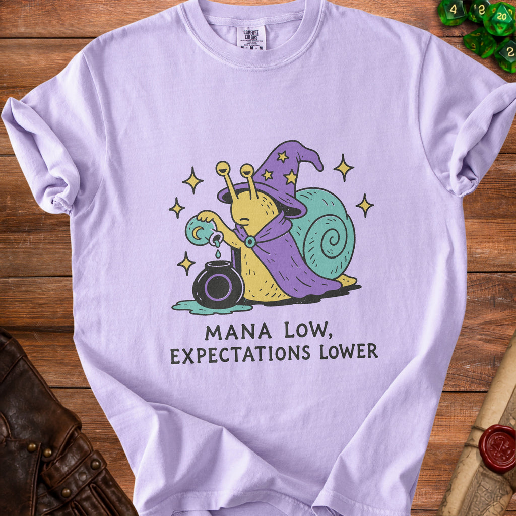 Lavender t-shirt with a cartoon snail wizard holding a potion and text "Mana Low, Expectations Lower."