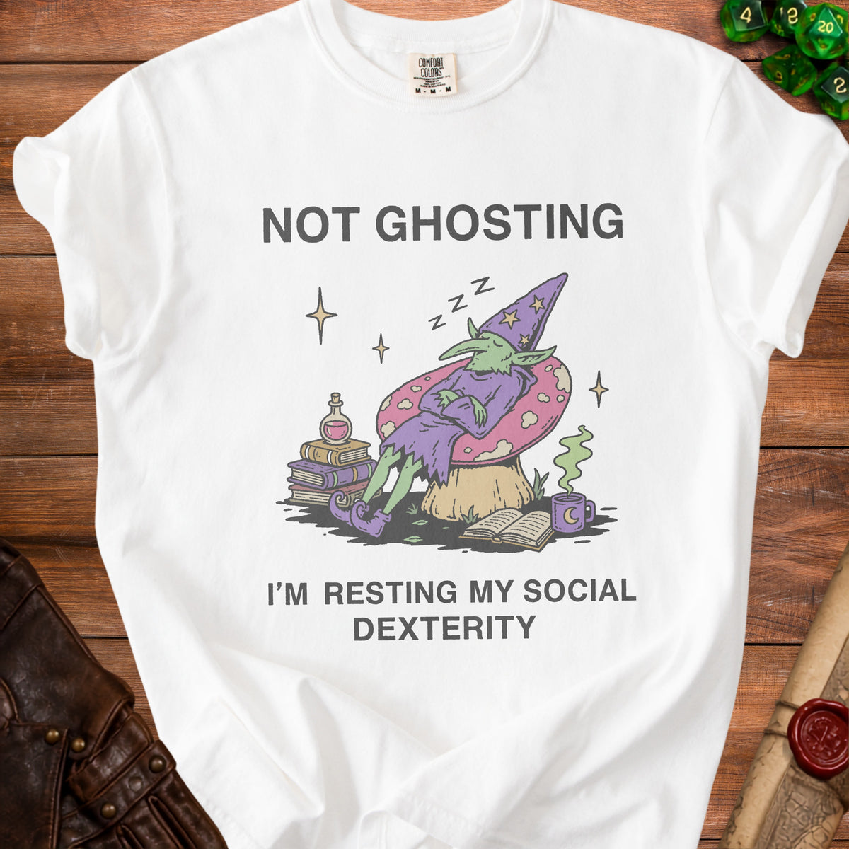 White t-shirt with illustration of sleeping wizard goblin and text "NOT GHOSTING I'M RESTING MY SOCIAL DEXTERITY".