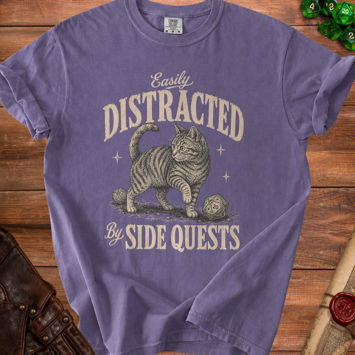 Purple t-shirt with a cat and dice, text reads "Easily Distracted By Side Quests."