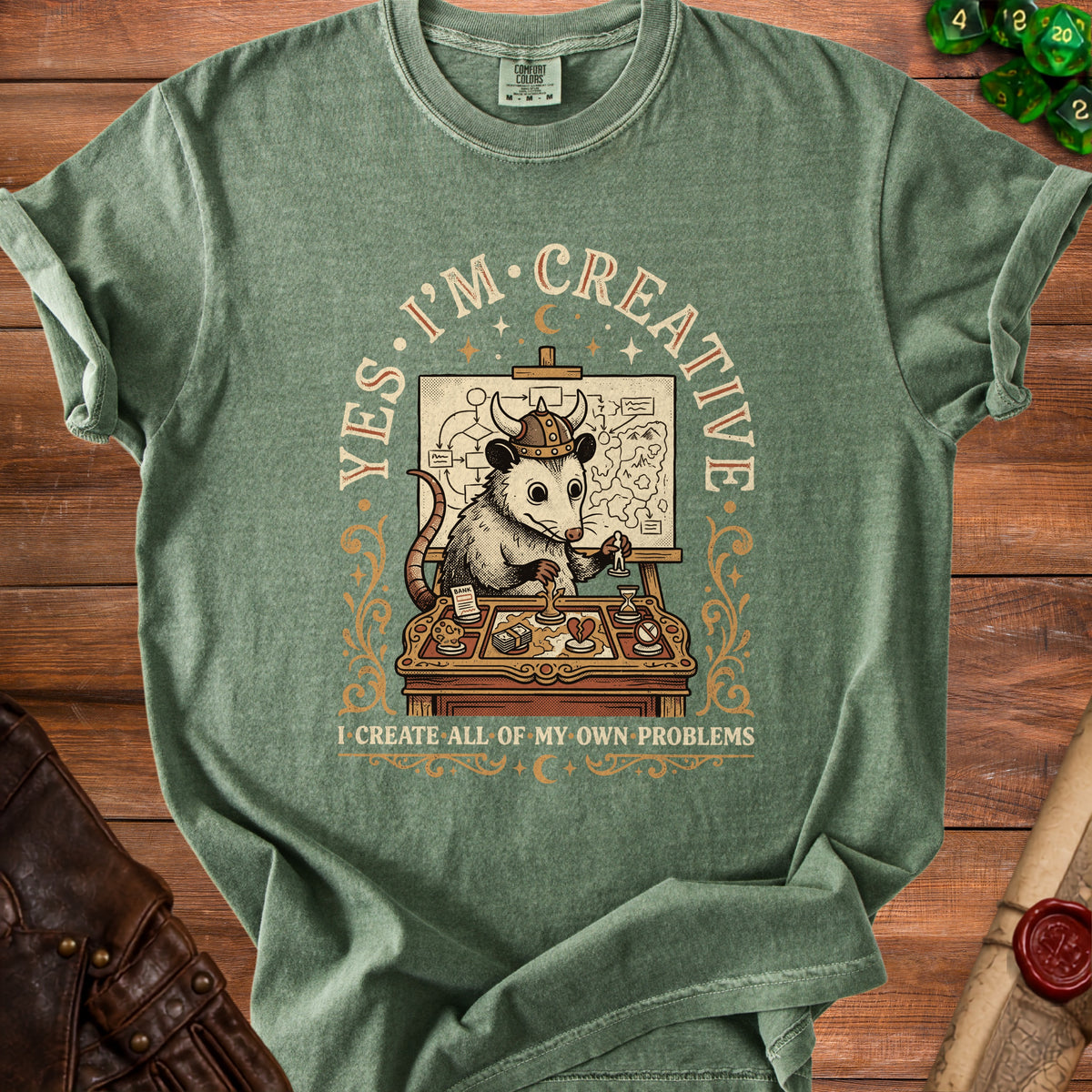 Green t-shirt with possum wearing viking helmet and text "YES. I'M CREATIVE I CREATE ALL OF MY OWN PROBLEMS".