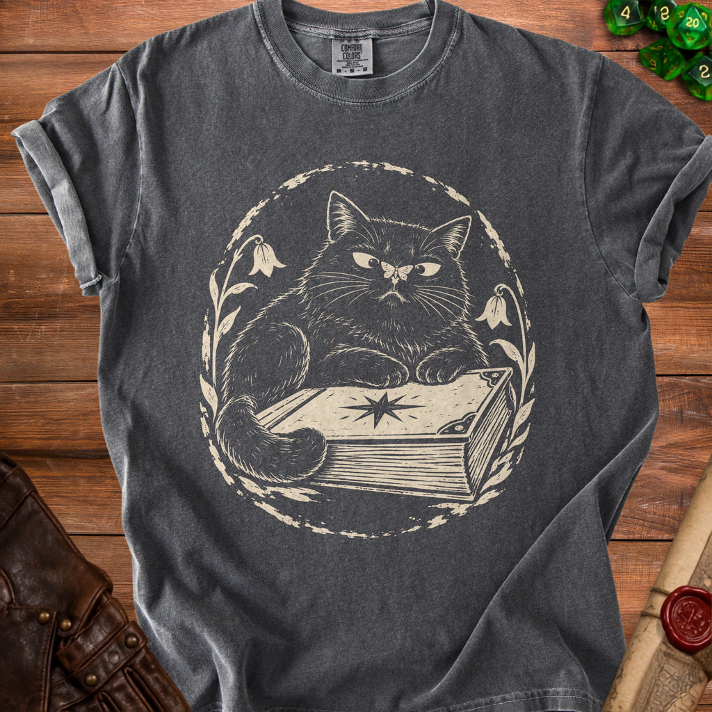 Dark grey t-shirt with a distressed print of a cat on a book.