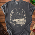 Dark grey t-shirt with a distressed print of a cat on a book.