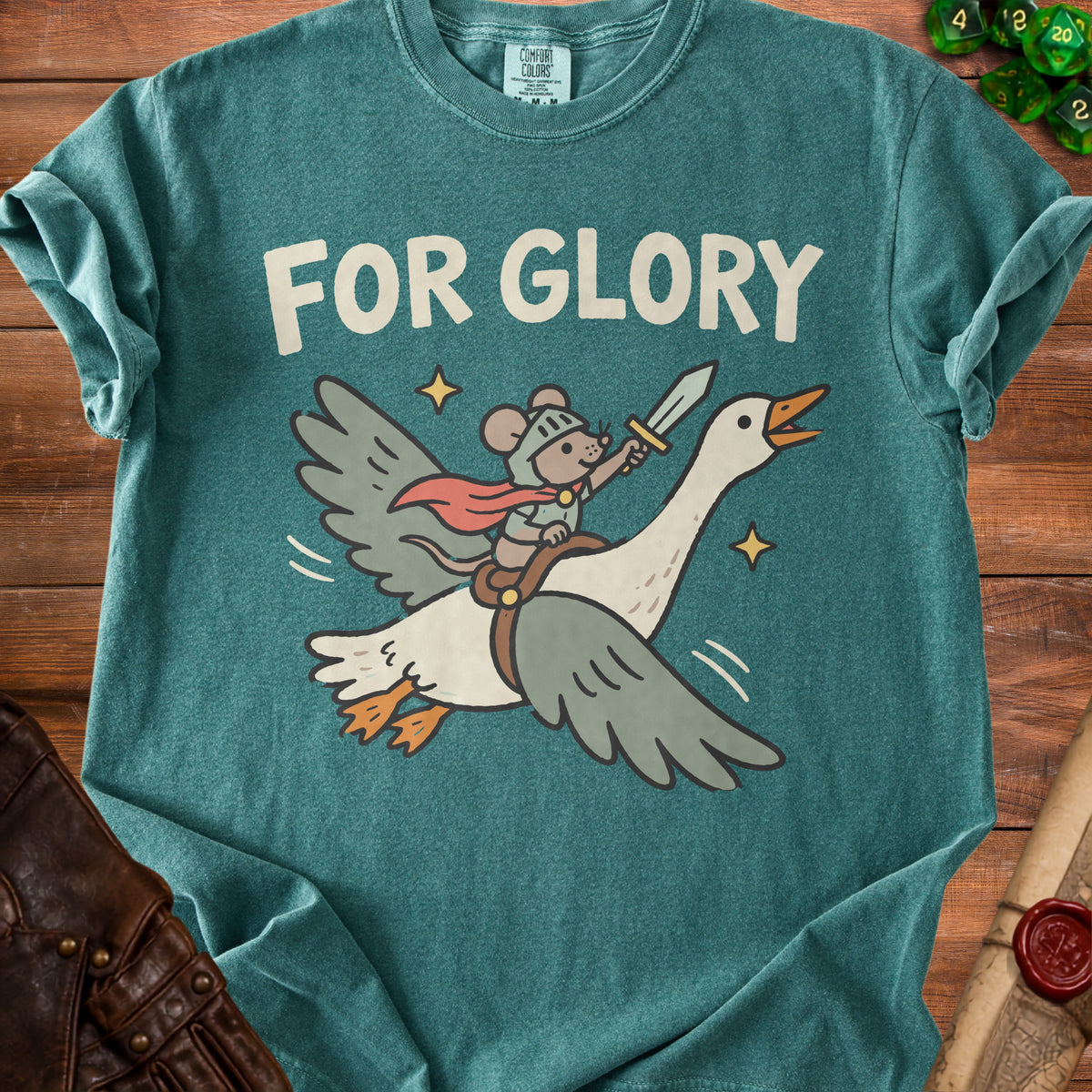 A green t-shirt featuring an illustration of a mouse knight riding a flying goose with the text FOR GLORY.