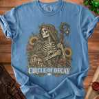 Blue t-shirt with skeleton, sunflowers, mushrooms, and text "Circle of Decay".