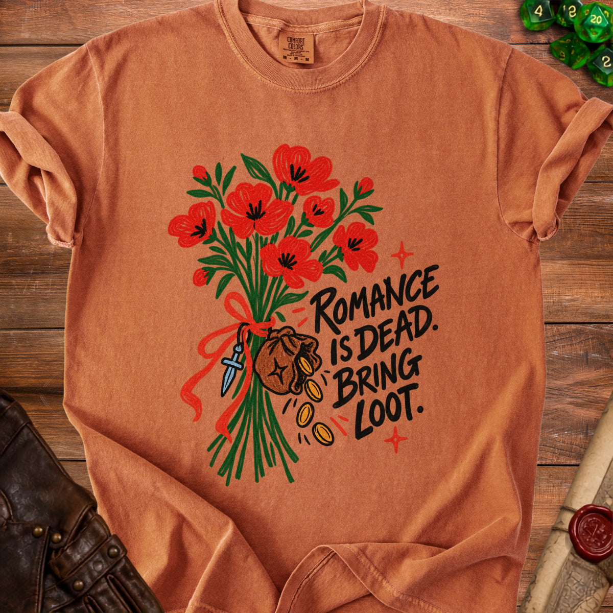 Orange t-shirt with poppies, dagger, money bag, and text "ROMANCE IS DEAD. BRING LOOT."