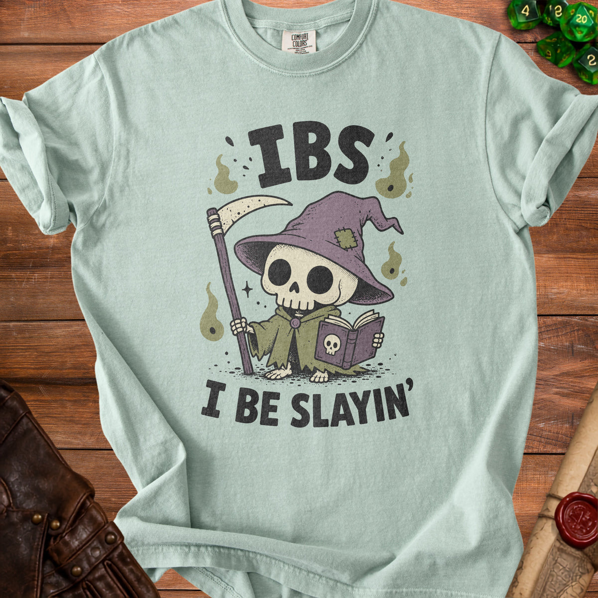 Light blue t-shirt with a grim reaper skeleton graphic and text "IBS I BE SLAYIN'".
