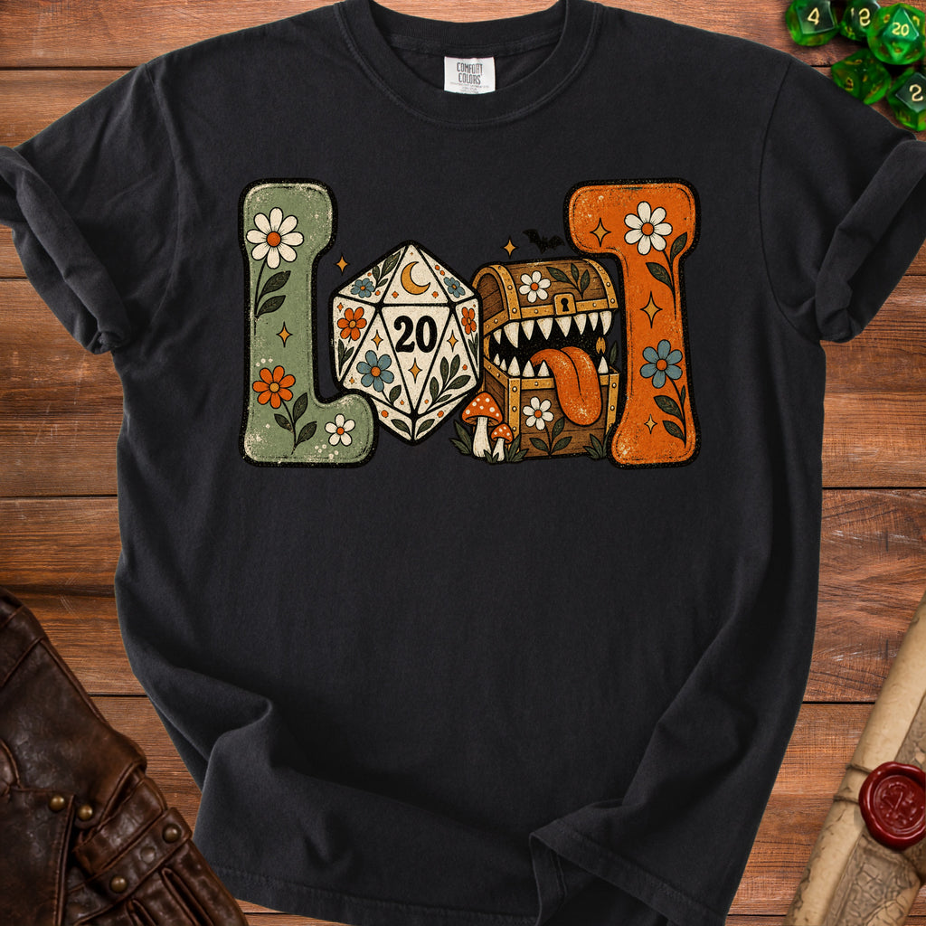 T-shirt graphic with d20, monster chest, mushrooms, and floral designs.