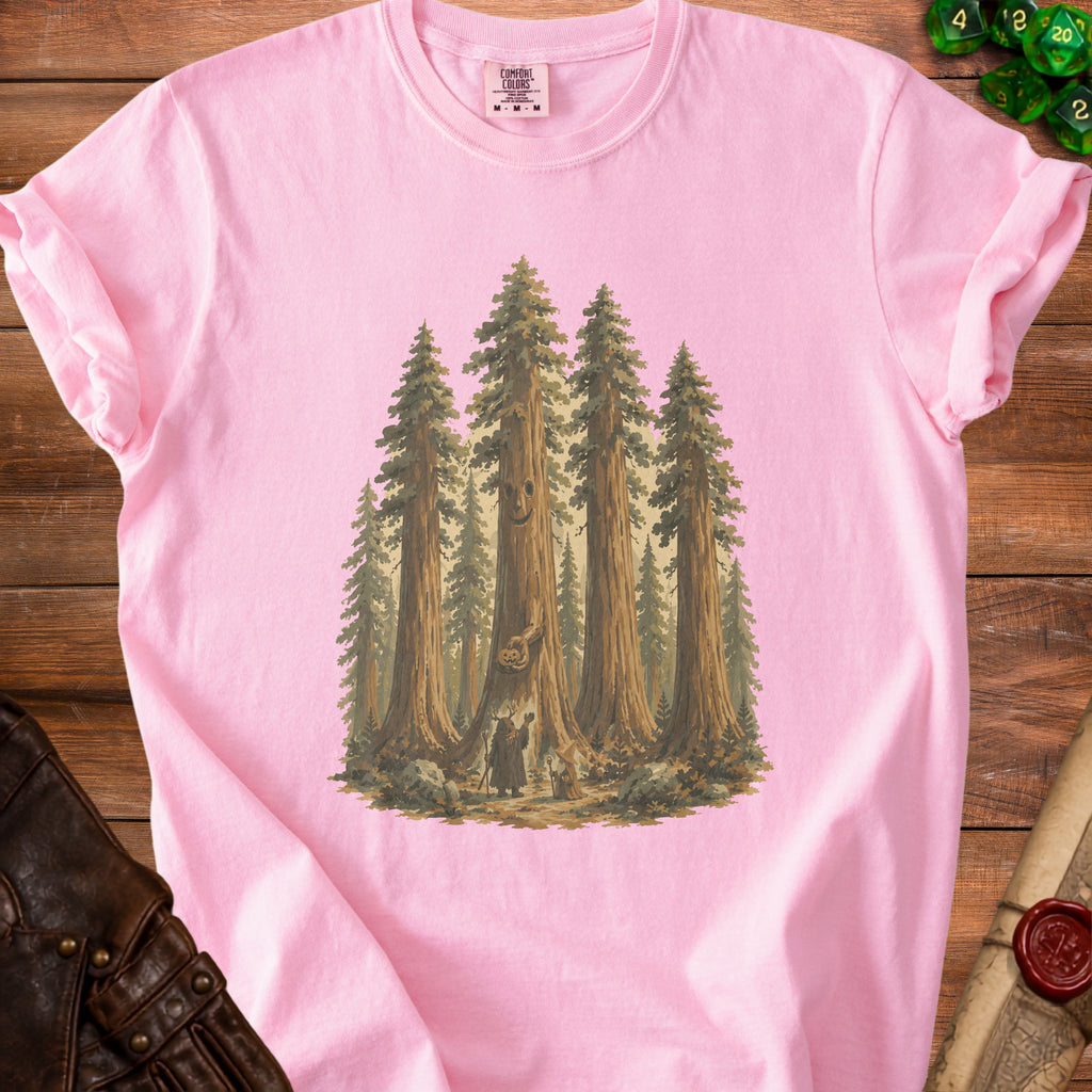Pink t-shirt with illustration of sequoias, two figures, and a jack-o'-lantern.