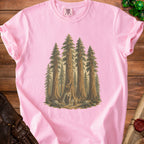 Pink t-shirt with illustration of sequoias, two figures, and a jack-o'-lantern.
