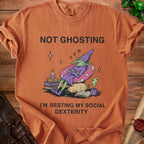 Orange t-shirt with "Not Ghosting I'm Resting My Social Dexterity" and goblin graphic.
