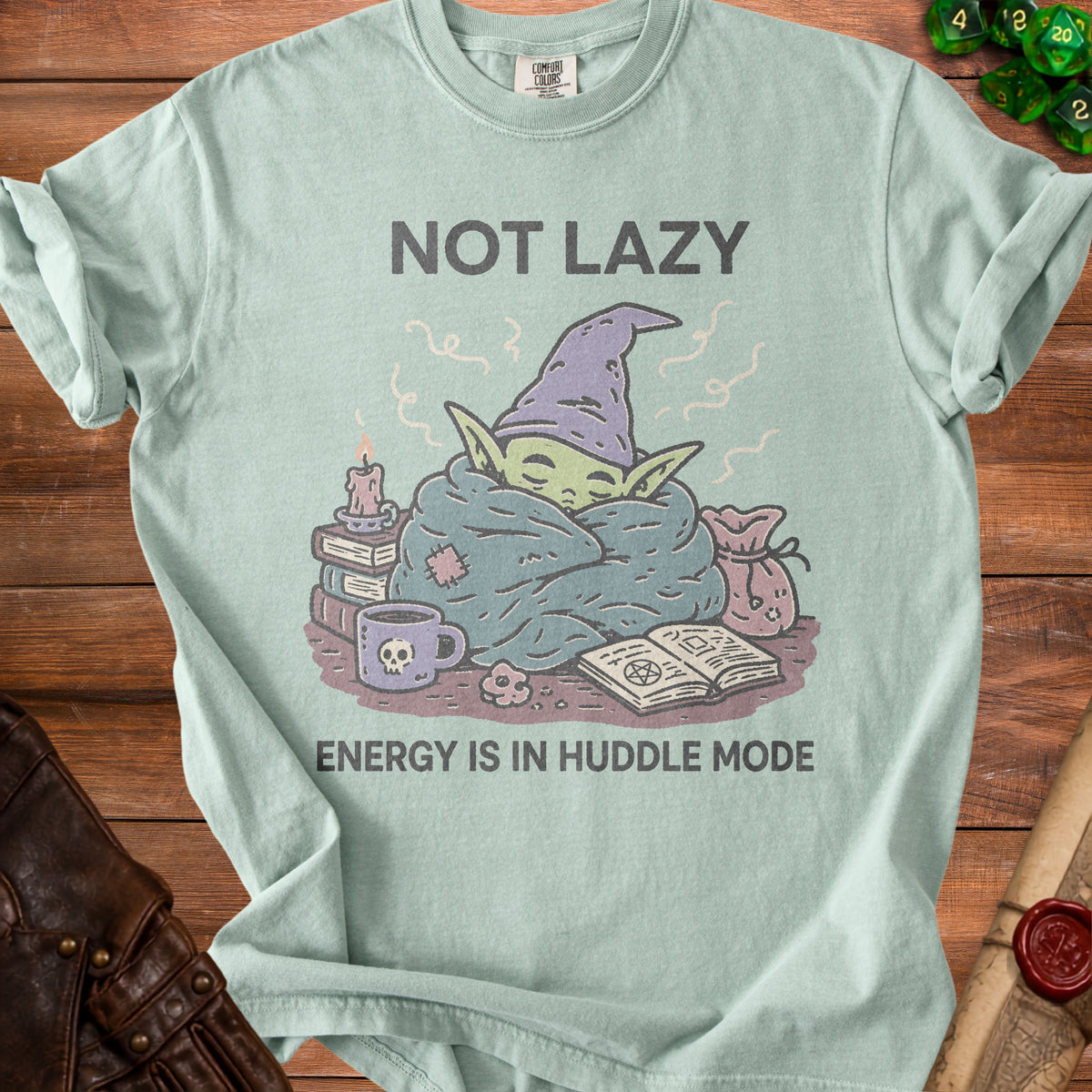 Light blue t-shirt with "NOT LAZY ENERGY IS IN HUDDLE MODE" text and sleepy creature graphic.