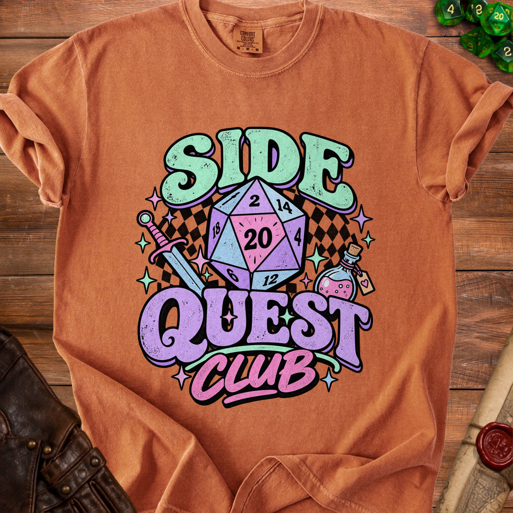 Orange t-shirt with "Side Quest Club" text, a d20 die, sword, and potion.