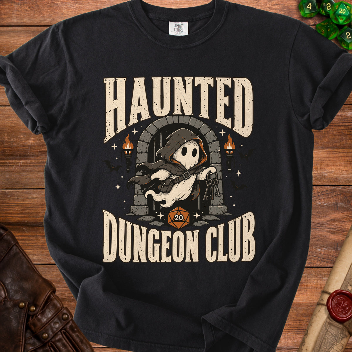 A black t-shirt with a vintage graphic of a ghost in a dungeon doorway and text reading Haunted Dungeon Club.