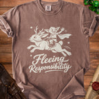 Brown t-shirt with cream graphic of a goblin riding a reindeer, reading "Fleeing Responsibility."