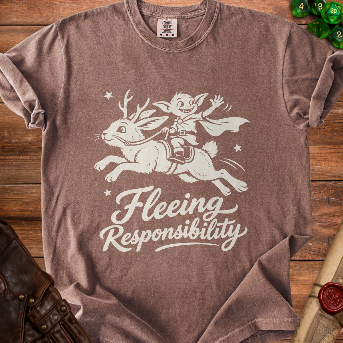 Brown t-shirt with cream graphic of a goblin riding a reindeer, reading "Fleeing Responsibility."
