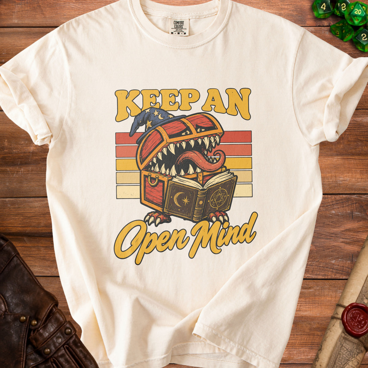 Cream t-shirt with vintage-style graphic of a treasure chest monster reading a book.