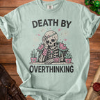 Light blue t-shirt with a skeleton graphic and text "DEATH BY OVERTHINKING."