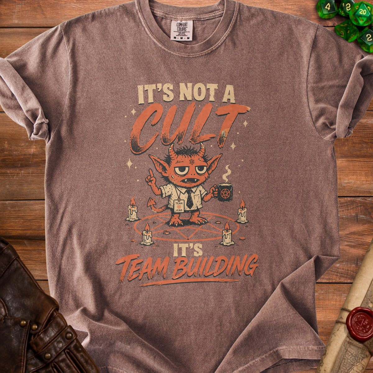 Brown t-shirt with graphic "It's not a cult, it's team building" and a devil.