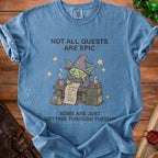 Blue t-shirt with a cartoon goblin wizard and text: "Not All Quests Are Epic, Some Are Just Getting Through Tuesday."