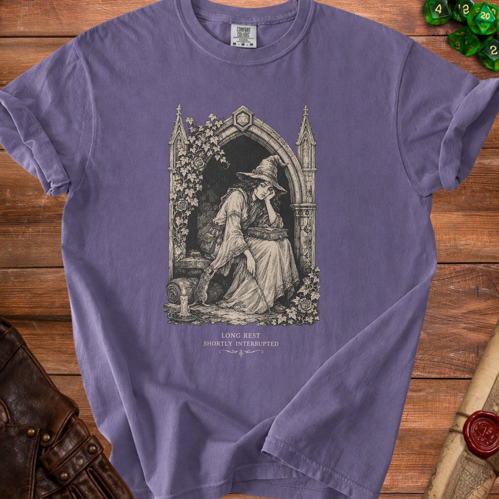 T-shirt with an illustration of a tired witch reading a book, text "LONG REST SHORTLY INTERRUPTED".