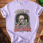 Lavender t-shirt with skeleton graphic and text "DEATH BY OVERTHINKING".