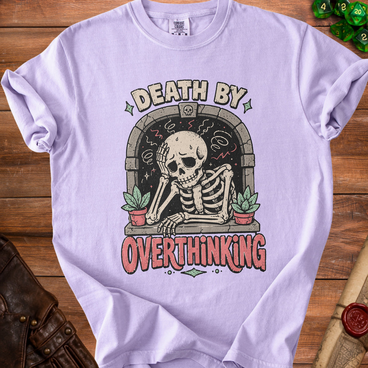 Lavender t-shirt with skeleton graphic and text "DEATH BY OVERTHINKING".