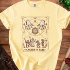 T-shirt graphic with hands, d20 die, wizard, warrior, rogue, and archer below text "Master of Fate".