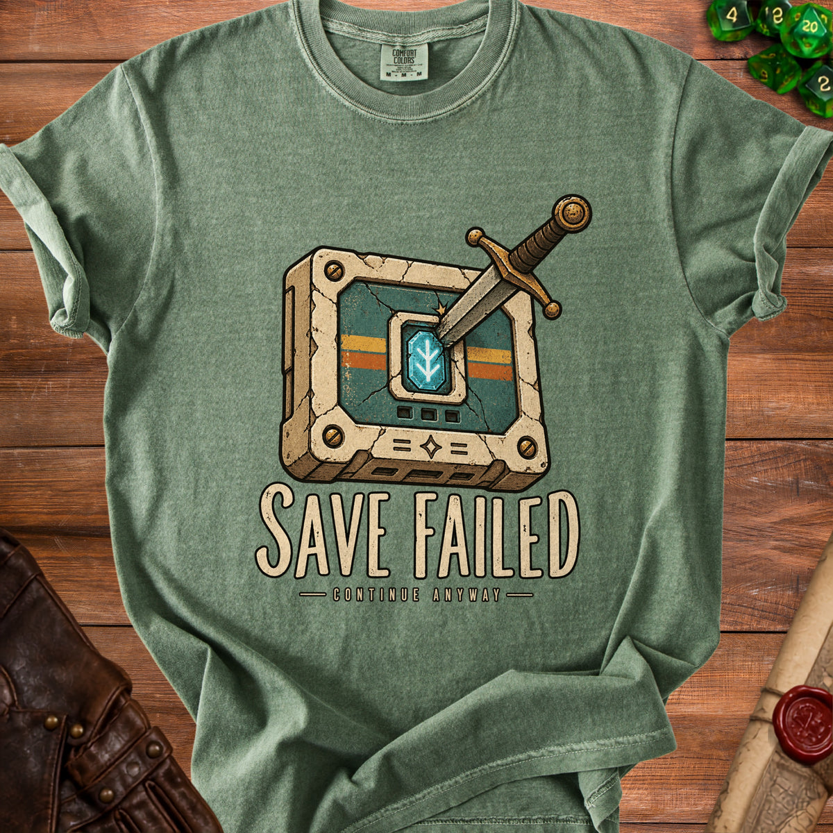 Green t-shirt with a sword stuck in a cracked game save icon and text "SAVE FAILED CONTINUE ANYWAY".