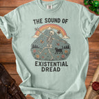 T-shirt with skeleton, cat, rainbow, mountain, and text "The Sound of Existential Dread."