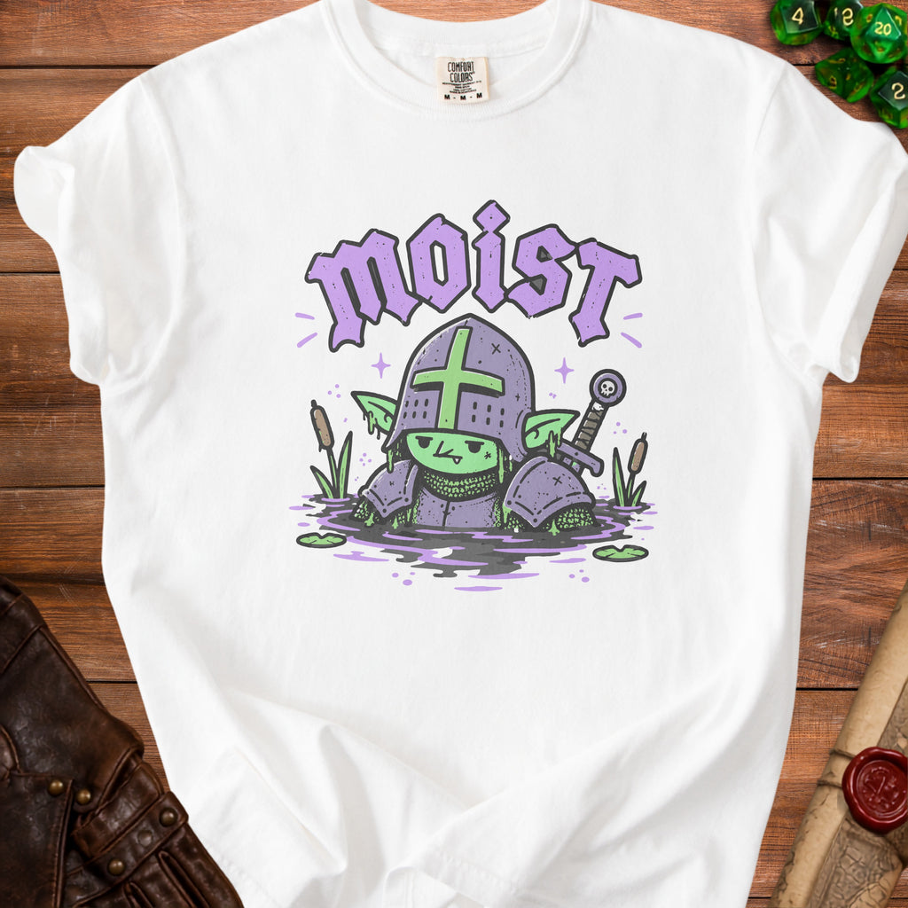 White t-shirt with a cartoon goblin in armor in the swamp, with the word "moist."